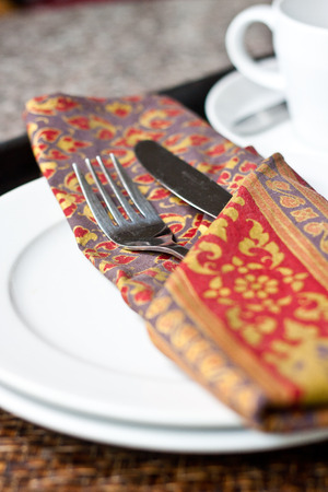 Fork and Knife in Napkin on the Plate
