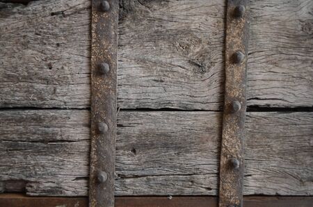 Vintage wooden door with metal belts の写真素材
