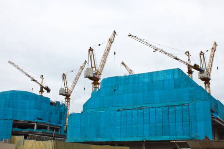  It shows construction cranes and unfinished house on the skylineの写真素材