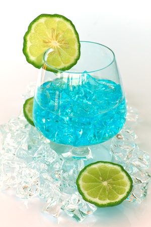 Stock Photo - glass of blue cocktail with lime on white backgroundの写真素材
