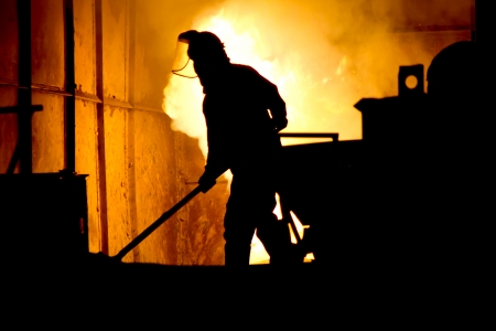 Stock Photo - Hard work in a foundry, melting ironの写真素材