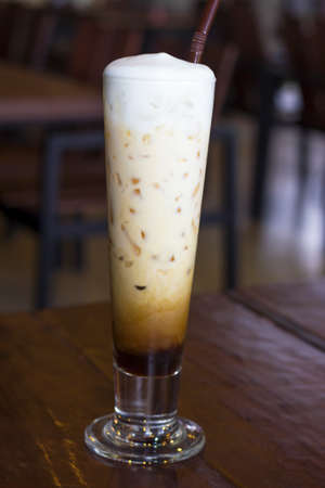 Stock Photo - Coffee with Ice on a teak wood tableの写真素材