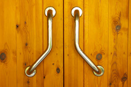Wooden doors with brass handle and lock.の写真素材