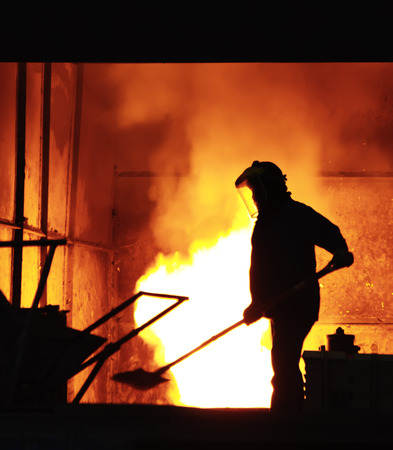 steel worker takes a sample from ovenの写真素材