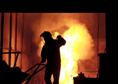 steel worker takes a sample from oven