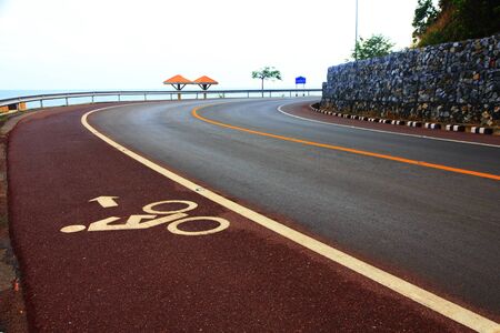 Bicycle lane. White mark of bicycle and white arrow pointing one wayの写真素材