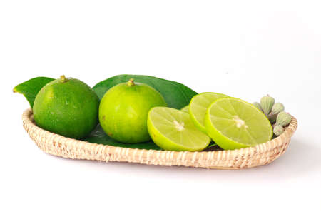 Fresh lime in basket,white isolate.の写真素材