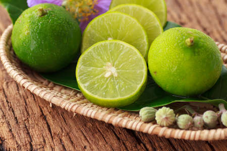 Fresh green lime on old wooden backgroundの写真素材