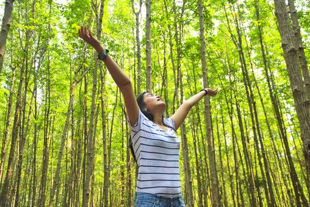 Beautiful young woman enjoys in nature.の写真素材