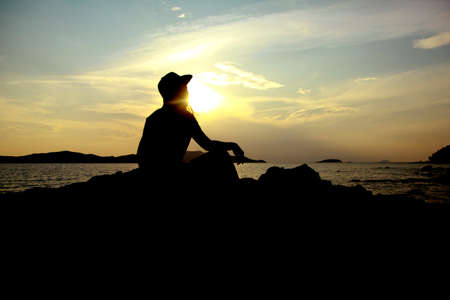 Twilight Scene. Sunset on the beach with a lonely girlの写真素材