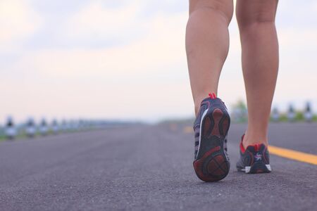 athlete running sport feet on trail healthy lifestyle fitnessの写真素材