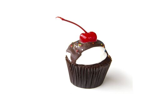 Chocolate cup cake and cherry on white backgroundの写真素材