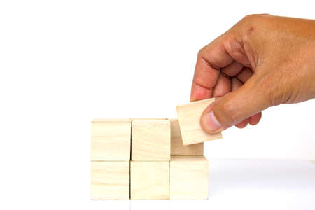 hand holding a piece of wooden jigsawの写真素材