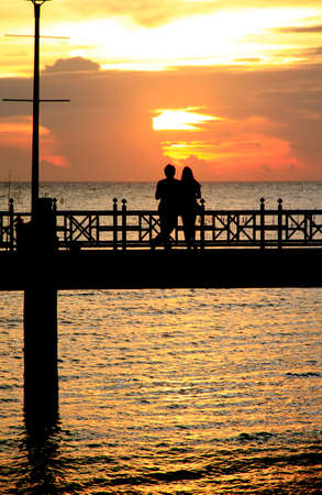 People silhouettes on the sunsetの写真素材