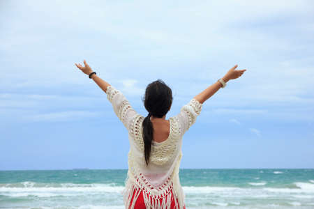 Young woman relaxing near the sea.の写真素材