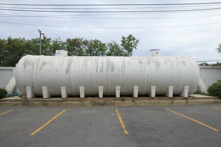 Water tank off the ground on concrete supportsの写真素材