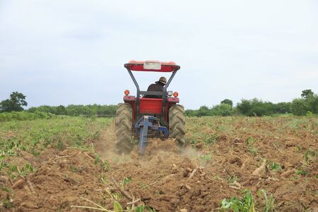 Farmer was drove tractor plowing the soil to picup cassavaの写真素材