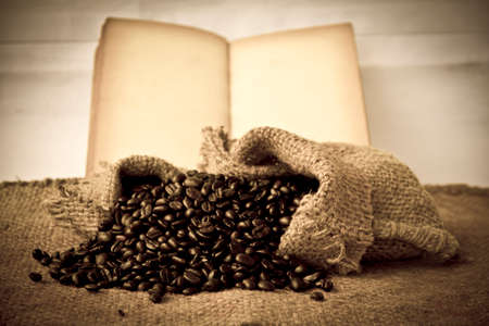 coffee beans and old book sackcloth backgroundの写真素材
