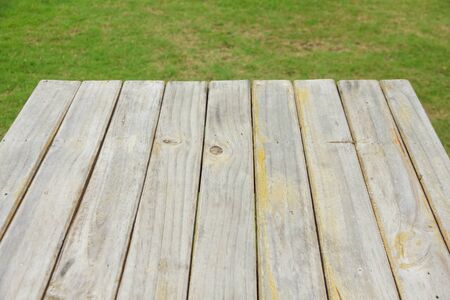 Green grass blurred background and old brown wooden floorの写真素材