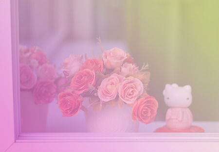 Bouquet of artificial flowers in a windowの写真素材