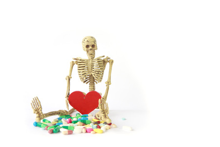 Human skeleton with tablets on white backgroundの写真素材