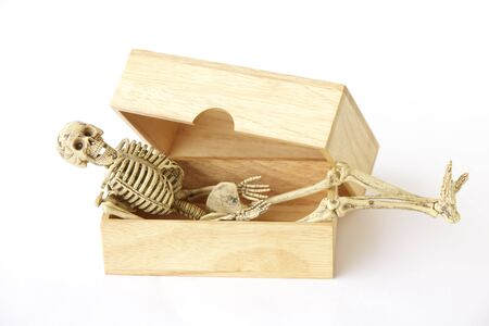 Skeleton in wood box ,Still life on white backgroundの写真素材