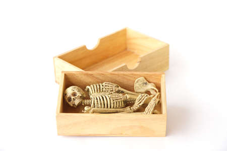Skeleton in wood box ,Still life on white backgroundの写真素材
