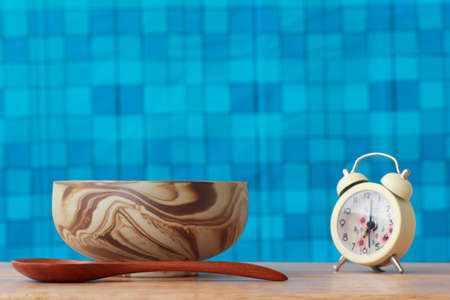 cup soup and alarm clock on wood background.の写真素材