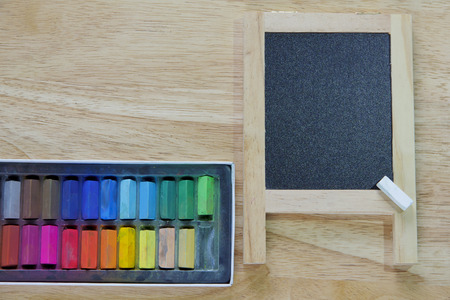 Blank blackboard with colored chalks Horizontal compositionの写真素材
