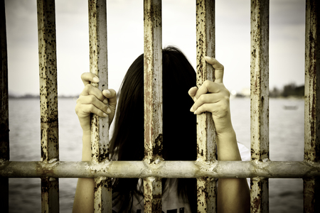 Hands of the prisoner on the prisonの写真素材