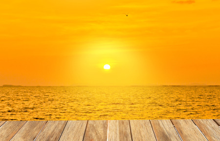 Wooden platform beside tropical beach at sunset timeの写真素材