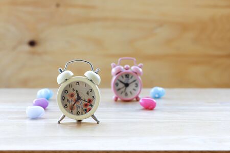 Vintage alarm clock on wooden background