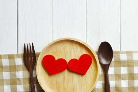 Wooden bowl and wooden spoon on rustic wooden tableの写真素材