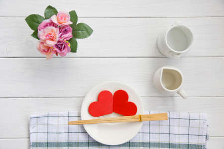 Red heart on plate on wooden backgroundの写真素材
