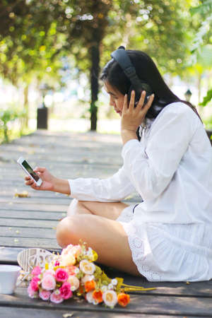 Beautiful Young Woman with Headphones Outdoorsの写真素材
