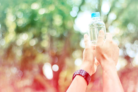 Man holding a bottle of water soft focus vintage styleの写真素材