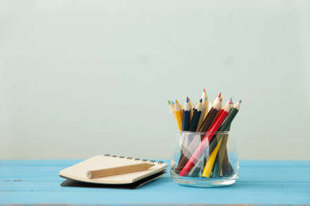 colored chalks on wooden table vintage effect style picturesの写真素材