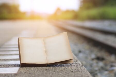 open book on the railroad tracks, with a filter effect