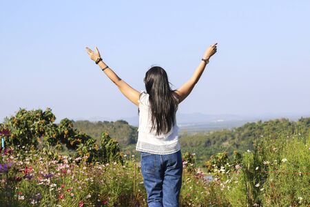 Happy girl enjoying the freedom and happiness on sunny meadowの写真素材