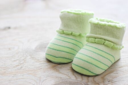 vintage newborn shoes for baptism on wooden backgroundの写真素材