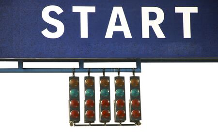 Racing green traffic light on background sky