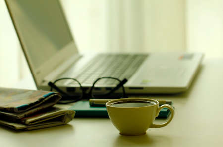 Image of business table with a cup of coffee and norebookの写真素材