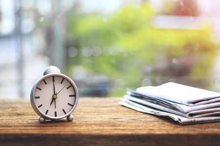 Natural background with retro alarm clock on tableの写真素材