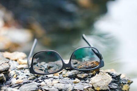 black sunglasses and sea backgroundの写真素材