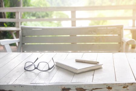 Business background - open notepad with pen on Vintage white wooden table, closeup with copy spaceの写真素材