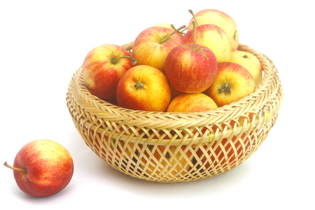 Fresh Little Apples in basket on wihte background. Selective focus.Healthy fruit concept.の写真素材