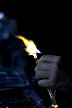 Close-up of glass piece melted by a flame.の写真素材