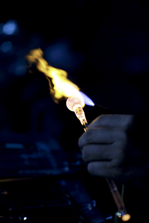 Close-up of glass piece melted by a flame.の写真素材