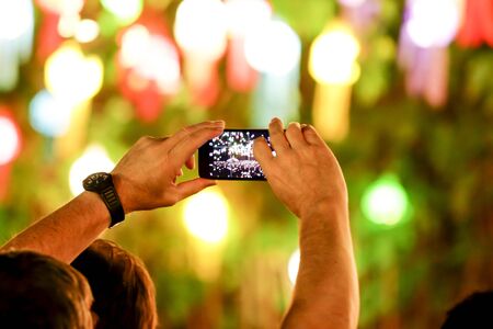 Capture video in festival at the phone camera in a bright lampsの写真素材