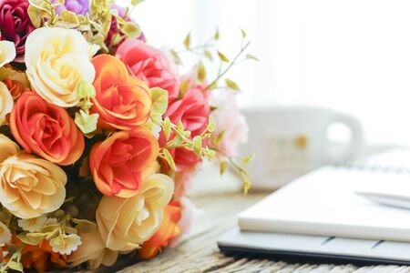 Plastic Floral Bouquet of Different Flowers on wooden Backgroundの写真素材